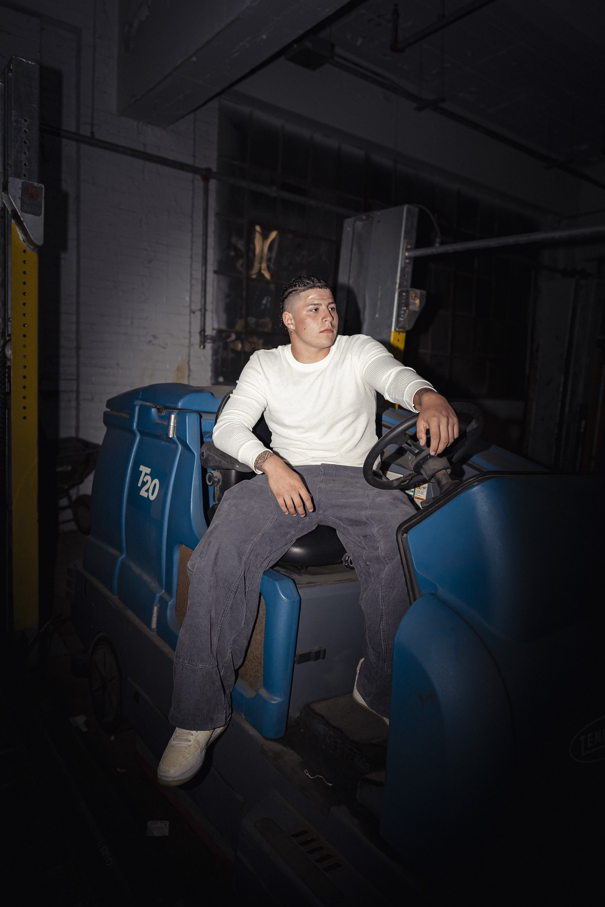 Dark indoor portrait with blue tones.